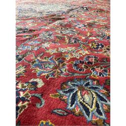 Persian rug, one central navy medallion with red field and floral motifs, surrounded by multiple borders 303cm x 430cm
