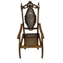 19th century walnut folding campaign chair, the carved cresting rail over bergere back and seat panel, raised on squared supports  