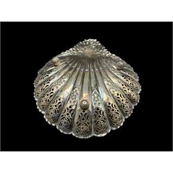 Late Victorian silver shell shape dish, the pierced border with flower heads and leaves, the flattened handle engravd with initials and on fluted ball feet 25cm x 20cm Sheffield 1895 Maker Atkin Bros. 6.8oz