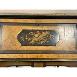 Late 19th to early 20th century French walnut bureau de dame, sliding with fall-front decorated with a jester and musical instrument pearwood inlay, crossbanding with stringining, opening to reveal two drawers and inset writing surface, the shaped apron with ebonised banding and rectangular mounts, raised on turned and fluted parcel gilt supports