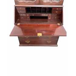 Georgian mahogany bureau bookcase, dentil cornice over two shaped and bevel glazed doors enclosing three shelves, sloped fall front under revealing fitted interior, four drawers to base, raised on bracket supports W106cm 