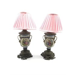 Pair of Continental porcelain table lamps decorated with panels of figures and flowers on metal base with birds and insects etc H37cm excluding fitting 