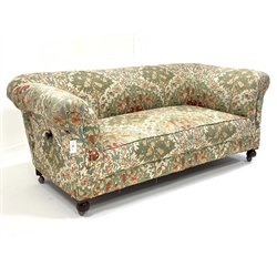 20th century drop arm chesterfield two seat sofa, upholstered in floral linen, and raised on  front bun supports and castors, W188cm