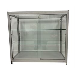 Low full height shop display or jewellery cabinet, glazed top and sides with two sliding doors, fitted with two glass shelves