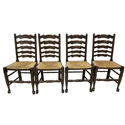 Set of eight (6+2) early 20th century stained beech dining chairs, high shaped ladder back over rush seats, on turned supports with pad feet united by swell-turned stretcher
