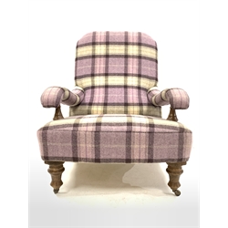 Victorian style low armchair upholstered in chequed wool, with open arms raised on turned oak front supports with castors