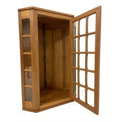 Knightman - oak panelled corner cabinet, single astragal glazed door with chamfered glazing bars, with wrought iron fittings and handle, carved with knight signature, by Horace Knight of Balk, Thirsk