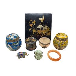19th century Japanese black lacquer box and cover decorated with butterflies and flowers, Chinese metal mounted polished stone bowl, polished stone amber colour bangle, carved green stone mask, Cloisonné model of an elephant etc
