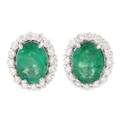 Pair of 18ct white gold oval cut emerald and round brilliant cut diamond cluster stud earrings, total emerald weight approx 3.00 carat, total diamond weight approx 0.75 carat