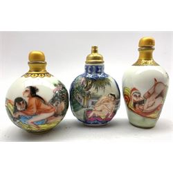 Three Chinese snuff bottles decorated with erotic scenes and blue character marks to base, tallest 9cm