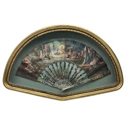 18th century fan, the mother-of-pearl sticks and guard carved, pierced, silvered and gilded, the paper leaf painted with mythological figures within gilt borders, framed and glazed, L55cm x H35cm. Provenance: From the Estate of the late Dowager Lady St Oswald