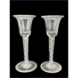 18th century cordial glass, the ogee bowl etched with flowers and butterfly on air twist stem with central knop, another with drawn funnel bowl on air twist stem, pair of 20th century cordial glasses with cotton twist stem and one other (5)