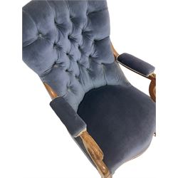 Victorian armchair, upholstered in blue buttoned back fabric, raised on turned supports, terminating in ceramic castors 