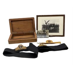Wooden box with Fleet Air Arm crest, two Fleet Air Arm wings, photograph of Fleet Air Arm prisoners of war in Oflag IXA, Spangenberg Castle, one other photograph and a sleeve rank band