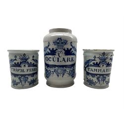 Pair of 18th century Delft drug jars inscribed 'E Trifol Febrin' and 'P Tammarind' in blue with birds, masks etc H11cm and another 'U Oculare' H17cm
