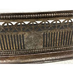 George III steel bow front fender, the pierced 'fretwork' frieze as stylized roundels above four engraved foliate roundels within beaded borders, L142cm together with a pair of steel tongs and poker stick (3)