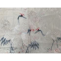 Early 20th century Japanese embroidered panel or bedspread, worked on ivory ground with three cranes amongst wisteria, Peonies and other flowers, with an ivory silk reverse and rope twist edging, L225cm x H150cm 