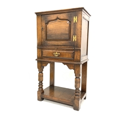 Titchmarsh and Goodwin oak drinks cabinet, fitted with arched panelled door over slide and one drawer, raised on turned supports united by under tier, 