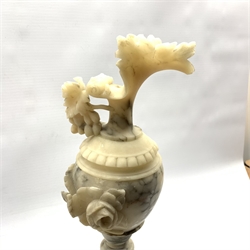 Pair of veined alabaster ewers, the handles modelled as trailing fruiting vines on turned socle bases, H53cm
