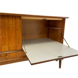 Peter Hayward for Vanson, retailed by Heal's of London - teak sideboard, bowed top over double cupboard, fall front compartment, and two drawers, on tapering angular supports, the right-hand drawer with ivorine plaque inscribed 
