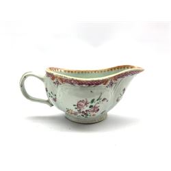 18th century porcelain sauceboat hand-painted with floral sprays beneath a pink scale border, L20cm 