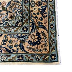 Persian Ardakan ivory ground rug, the field decorated with a large central lotus medallion surrounded by garlands of flowers, the triple-band border with symmetrical floral bouquet designs with indigo outlines