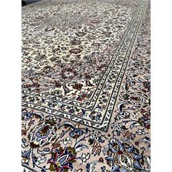 Persian fine Kashan ivory ground carpet centred by a floral medallion 292cm x 390cm