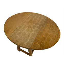 Fishman - figured oak occasional table, oval drop-leaf top, splayed tapered square supports united by stretchers, carved with fish signature, by Derek Slater, Crayke 