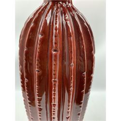 Contemporary red floor vase, of bottle form, with artificial flowers, 71cm