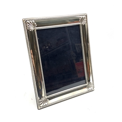 Silver table photograph frame with bead and shell border by Carr's of Sheffield, 2000 H22cm 