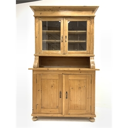 20th century pine country kitchen dresser, projecting cornice over double glazed doors enclosing two shelves, two cupboards under enclosing shelves