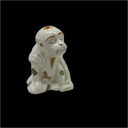 Unusual 19th century creamware model of a seated monkey, wearing robes and decorated with astrological symbols, base marked 2011, H10cm