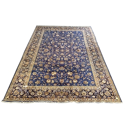 Persian Kashan ground carpet, the blue field with all over design centred by Herati motif, guarded border decorated with stylised interlaced foliate, 446cm x 317