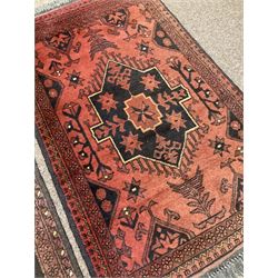 Two small Persian ground rugs, both with central medallions and floral motifs 