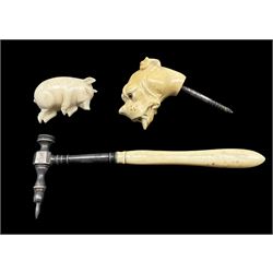 19th century walking stick finial in the form of a dogs head with glass eyes, a carved ivory model of a sleeping pig L5cm and a toffee hammer with an ivory handle 