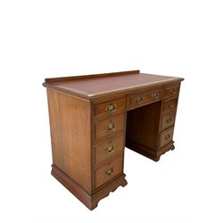Edwardian mahogany twin pedestal desk, the raised back and inset top over one long and eight graduated drawers 
