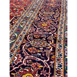 Persian fine Kashan red ground carpet, with floral medallion on red field with interlaced foliate, triple guarded border, 357cm x 254cm