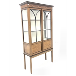  Edwardian mahogany display cabinet, frieze inlaid with boxwood floral swags and stringing, over tracery glazed doors enclosing two shelves, raised on square supports, W95cm, H173cm, D35cm  