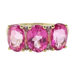 Gold three pink stone and diamond chip ring, stamped 9k