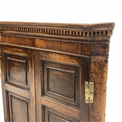 Georgian oak wall hanging corner cupboard, with dentil cornice over two panelled doors, (W79cm) and another similar Georgian corner cupboard, (W72cm)