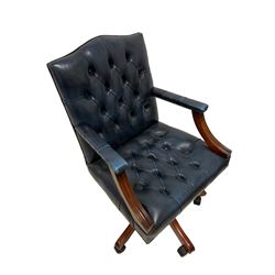Gainsborough design swivel desk chair, upholstered in deep blue finished buttoned leather with studwork, the adjustable and reclining seat raised on five splayed supports with castors 