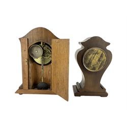 Two early 20th century wooden cased 8-day mantel clocks -  one with an oak case, twin barrel striking movement striking the hours on a bell, the other in a mahogany case with a timepiece movement and cylinder platform escapement, both dials with arabic numerals.