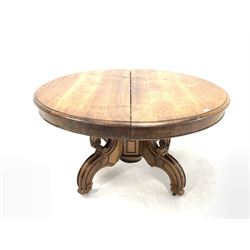 Victorian walnut circular extending dining table, the top raised on an octagonal column and four scrolled splayed supports with brass castors, decorated with incised ebonised detail, with two additional leaves,