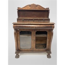 Irish Regency mahogany chiffonier, the raised back with scroll and lobe carved arched pediment and open shelf and three drawers, over gadroon carved top and cushion fronted drawer, two glazed doors enclosing shelf, flanked by 's' scroll pilasters, raised on paw front supports 