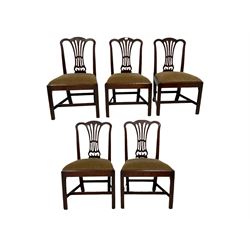 Set five George III mahogany dining chairs, the pierced splat back over drop in seat pad, raised on squared supports 