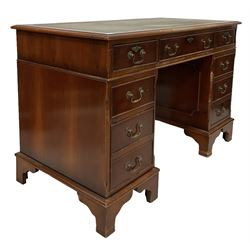 Georgian design yew wood desk, the inset top over fitted with nine drawers, raised on bracket supports 