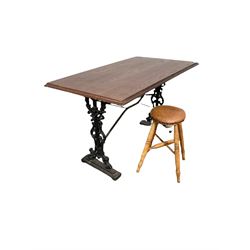 Pub table, the pine top over cast iron base, together with a hardwood stool, with leather seat, four turned supports united by an x stretcher 