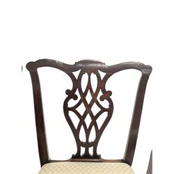 Pair of 19th century mahogany dining chairs, floral carved shaped crest rail over waved ladder backs, drop in upholstered seat pads and reeded and chamfered square supports, together with another pair of mahogany dining chairs 