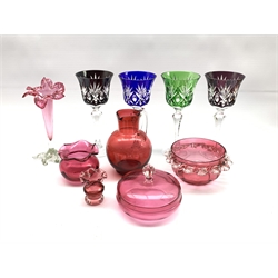 Four Hock glasses with coloured bowls and chamfered stems, , cranberry glass jug with clear glass handle H15cm, cranberry glass trumpet shape vase H20cm and four other pieces of cranberry glass