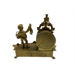 20th century cast brass mantle clock with a circular drum movement accompanied by a figure of a young boy with a catch of fish,  eight-day 